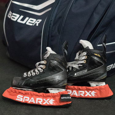 pair of skates in skate soakers with hockey bag